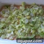 Shredded Lettuce Freshly shredded green lettuce leaves.