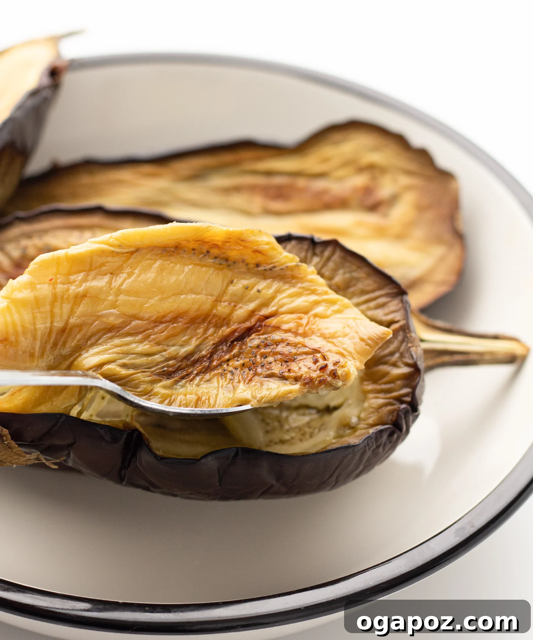 Crispy Air Fryer Eggplant 8 Air Fryer Eggplant scooping out the flesh.