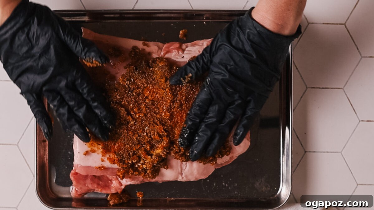 Perfect Air Fryer Pork Loin 6 Spreading the spice mixture evenly over the pork loin surface.