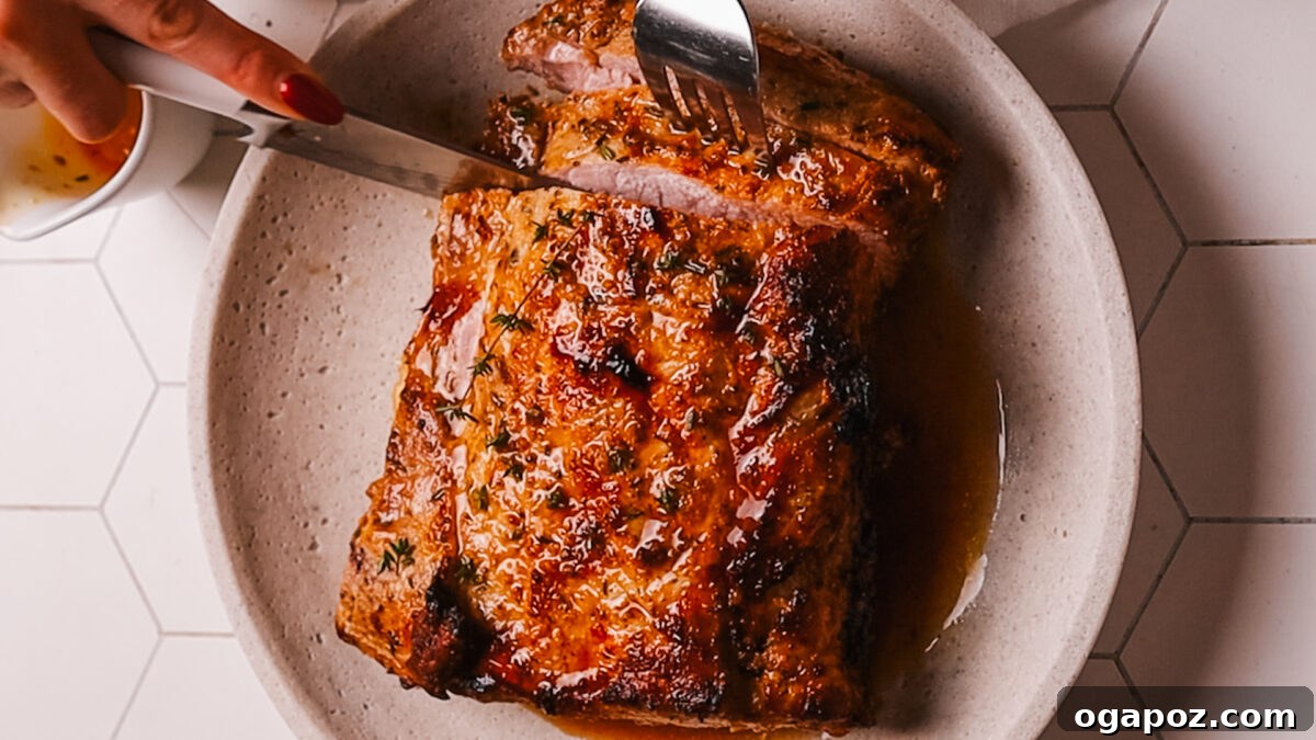 Perfect Air Fryer Pork Loin 8 Serving slices of air fryer pork loin with juices.