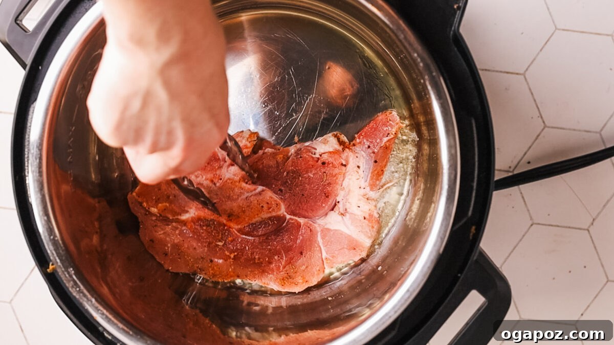 Fork Tender Instant Pot Pork Chops and Simple Gravy 6 Searing the pork chops in the Instant Pot until golden brown.