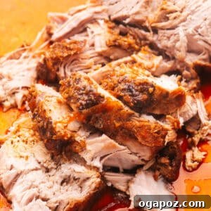 Slices of tender slow cooker pork loin on a cutting board, ready to serve.