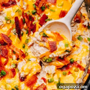 Creamy Crack Chicken served in a slow cooker with a spoon.