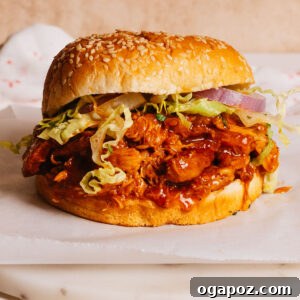 Crockpot BBQ Chicken served in a sandwich bun with coleslaw.
