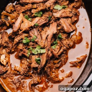 Shredded beef recipe in a crock pot, ready for various dishes.