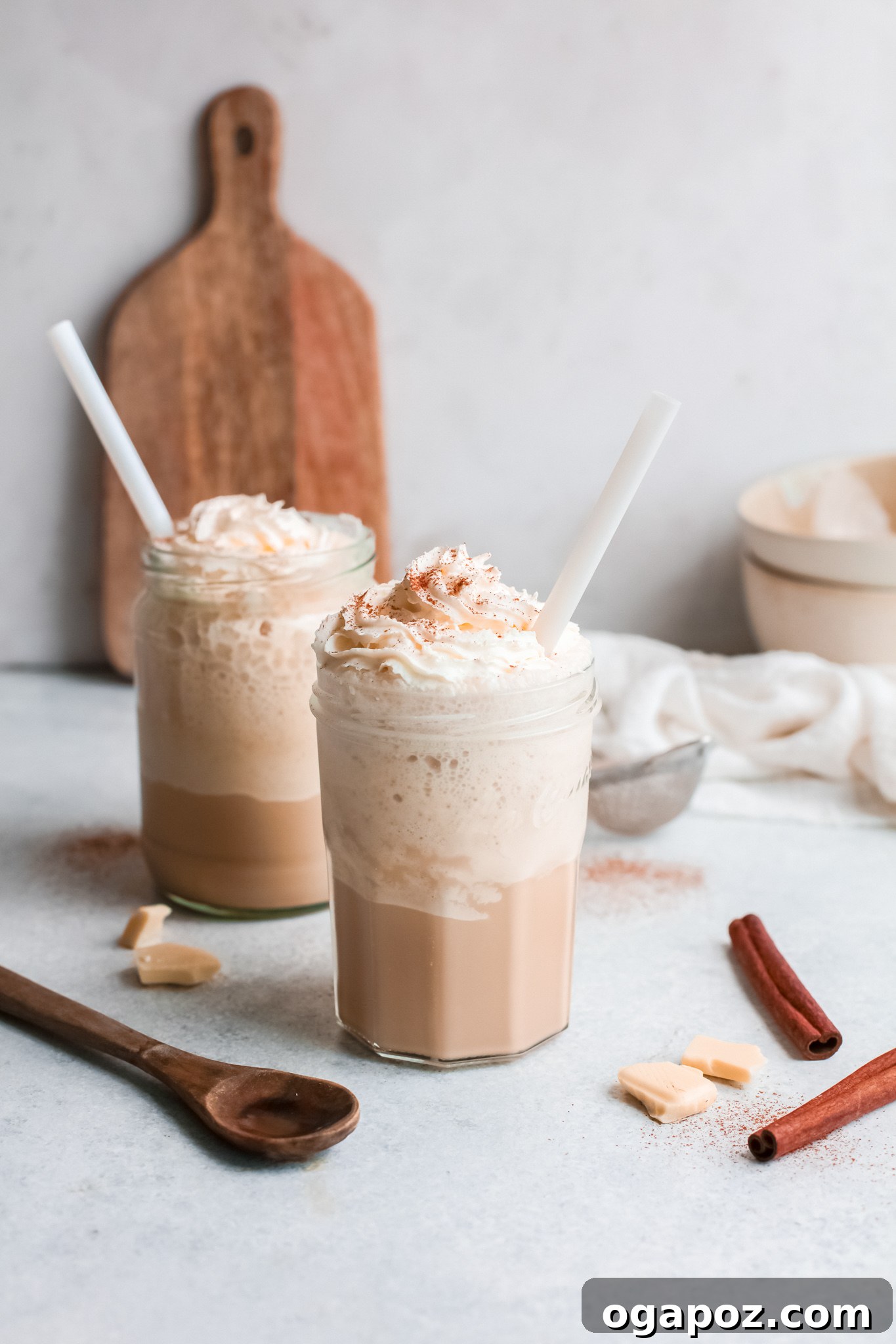 Velvet White Mocha Freeze 3 Two glasses of White Chocolate Frappuccino with straws and whipped cream topping.