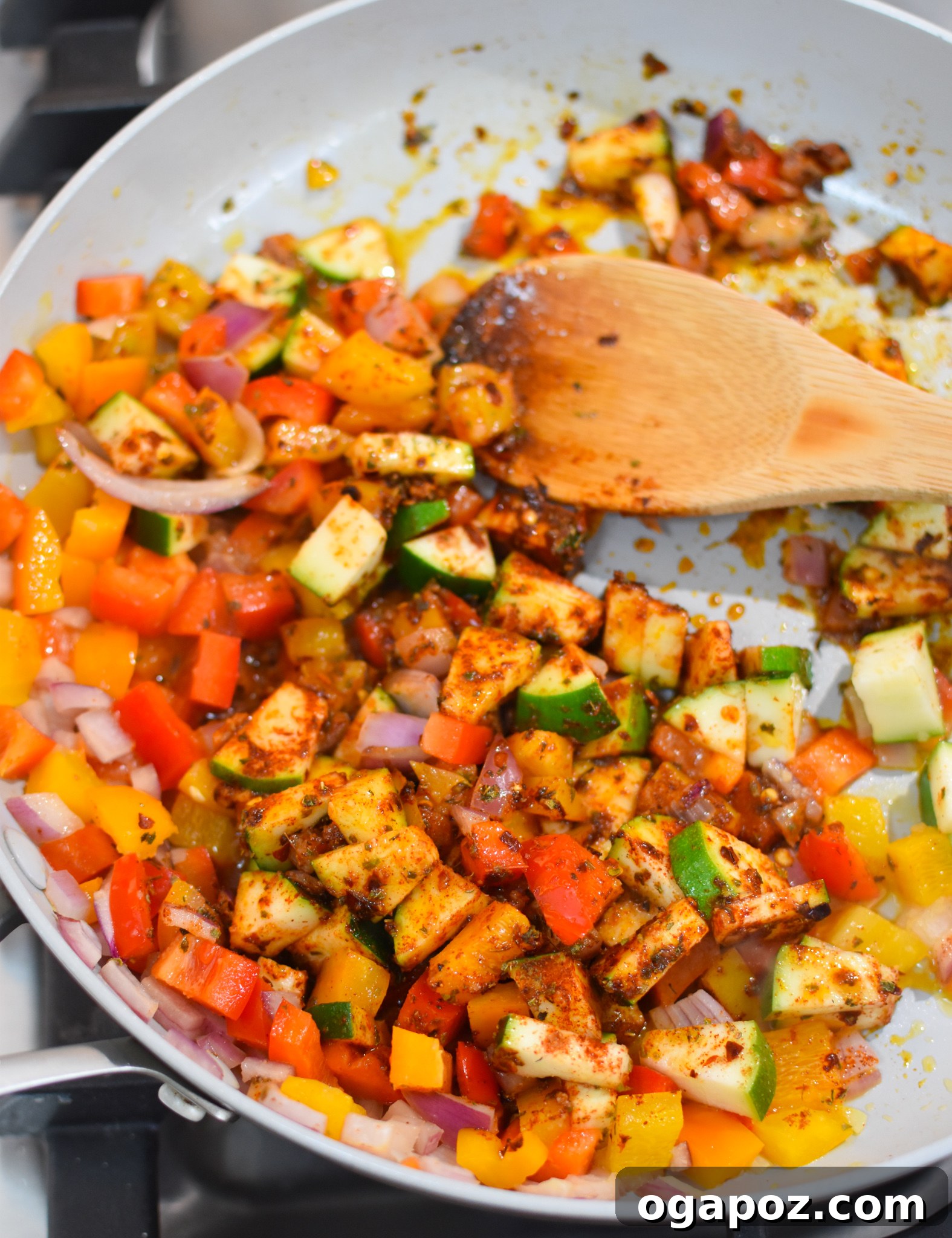 Sautéing vegetables for Mediterranean Orzo Pasta in a large skillet.