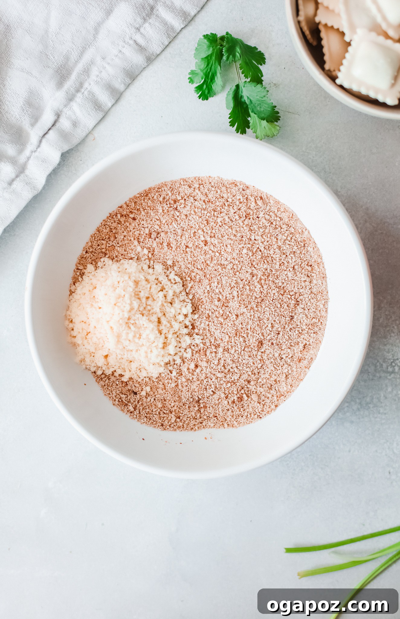 Crispy Air-Fried Ravioli Bites 5 Breadcrumbs, Parmesan cheese, and spices mixed in a bowl for the ravioli coating.