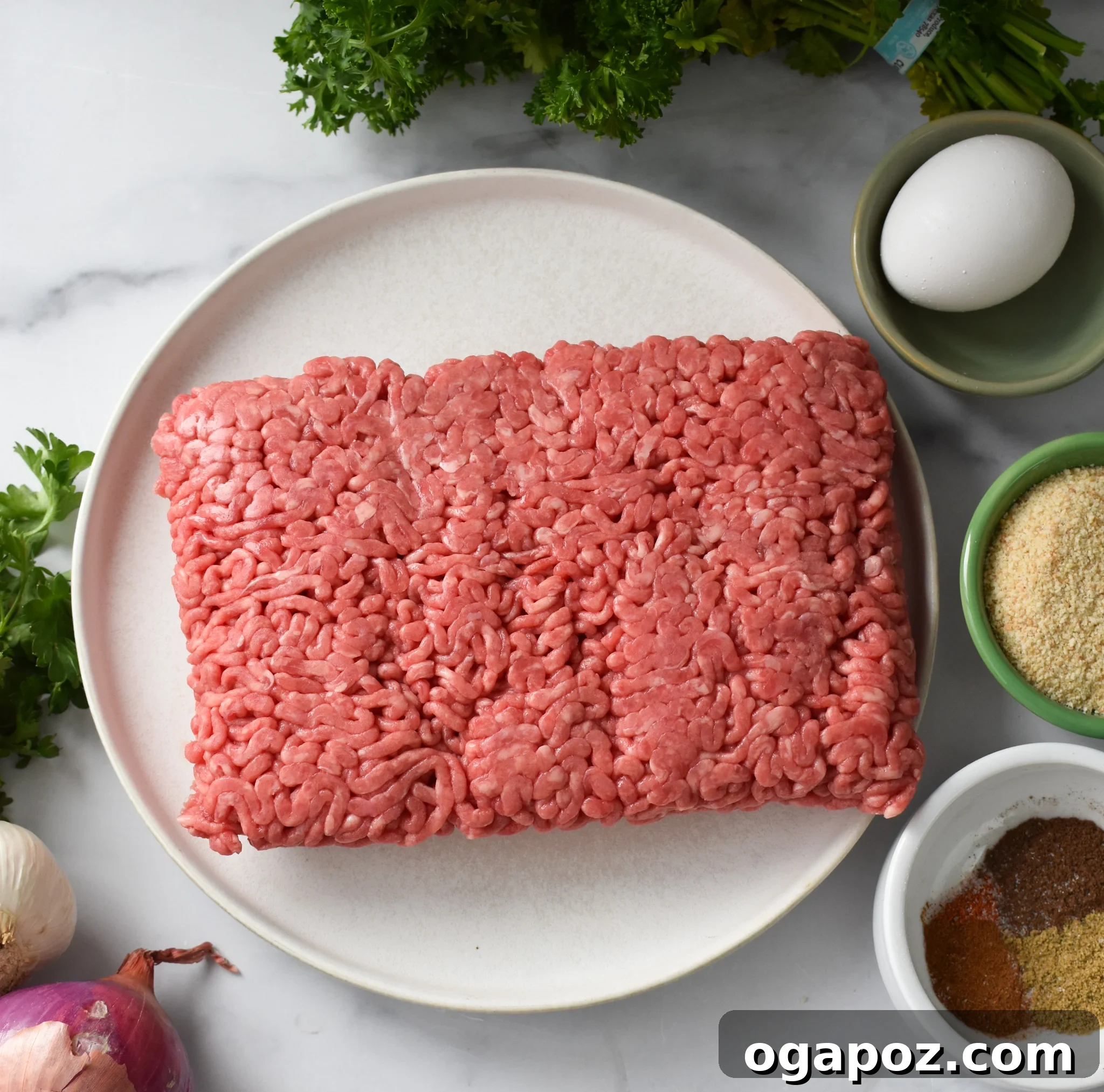 Succulent Mediterranean Baked Beef Meatballs 3 A collection of ingredients laid out, including ground beef, spices, herbs, and breadcrumbs, ready for making Mediterranean Baked Beef Meatballs.
