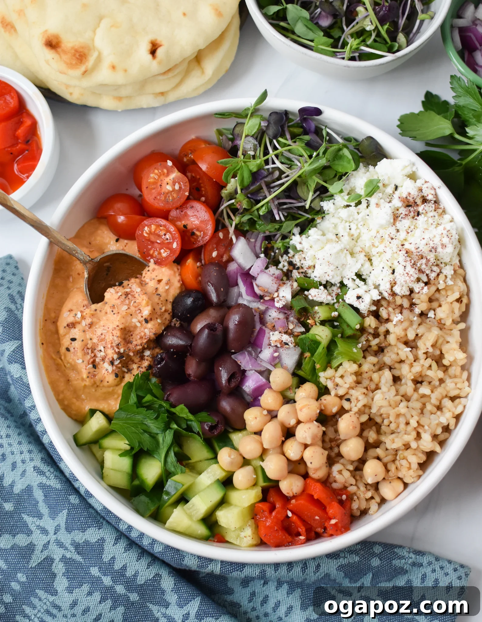 Vibrant Mediterranean Hummus Bowl 4 Close-up of an Easy Mediterranean Hummus Bowl with a spoon, ready to be enjoyed.