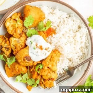Cauliflower Curry Recipe in a white bowl with a spoon