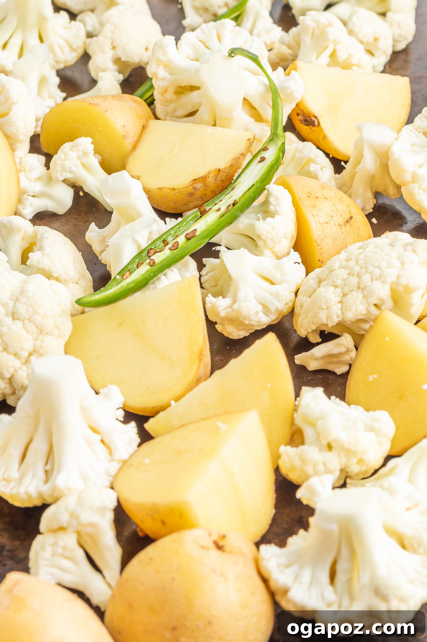Cauliflower Curry Recipe roasting potatoes on a pan.