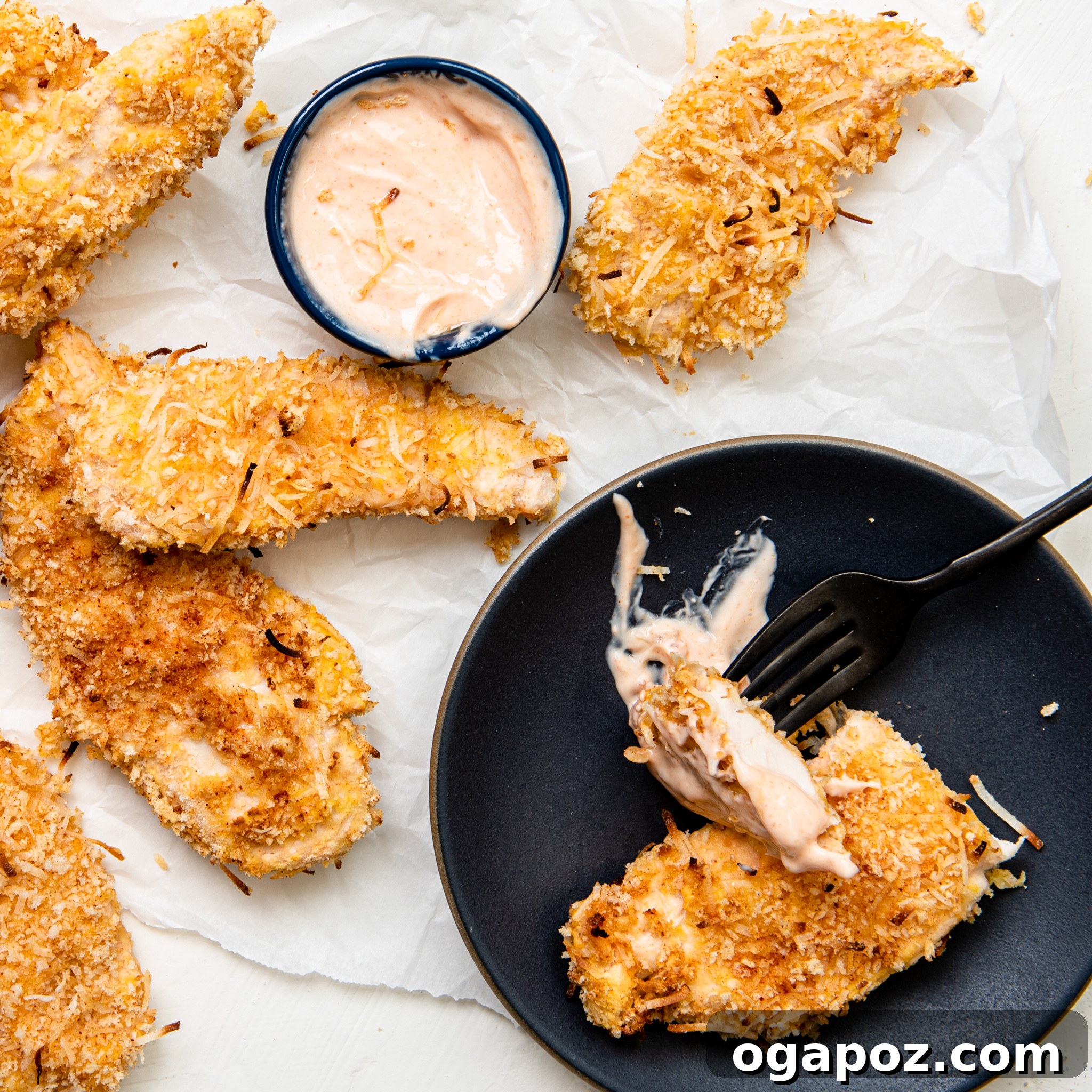 Air-Fried Crispy Coconut Chicken Strips 8 Close-up of Air Fryer Coconut Chicken Tenders with a fork.