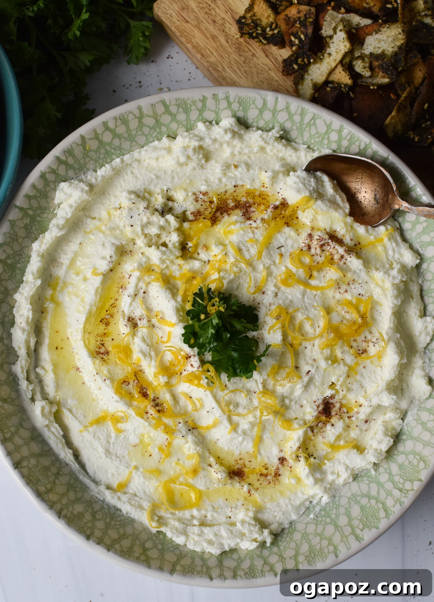 Tangy Lemon Feta Dip 2 Creamy Lemon Whipped Feta Dip served in a bowl with a spoon, garnished with lemon zest and za'atar.