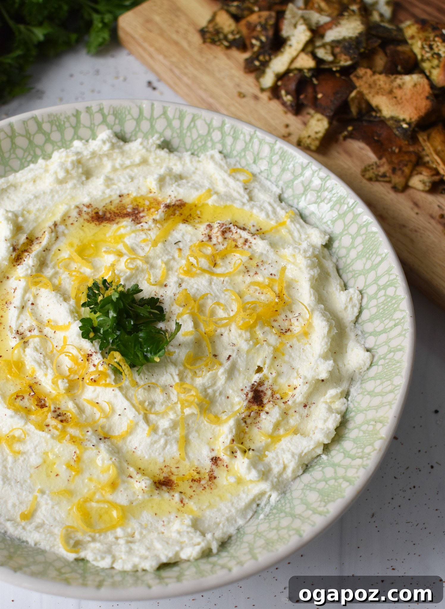 Tangy Lemon Feta Dip 4 Lemon Whipped Feta Dip garnished with fresh parsley, served in a shallow bowl.