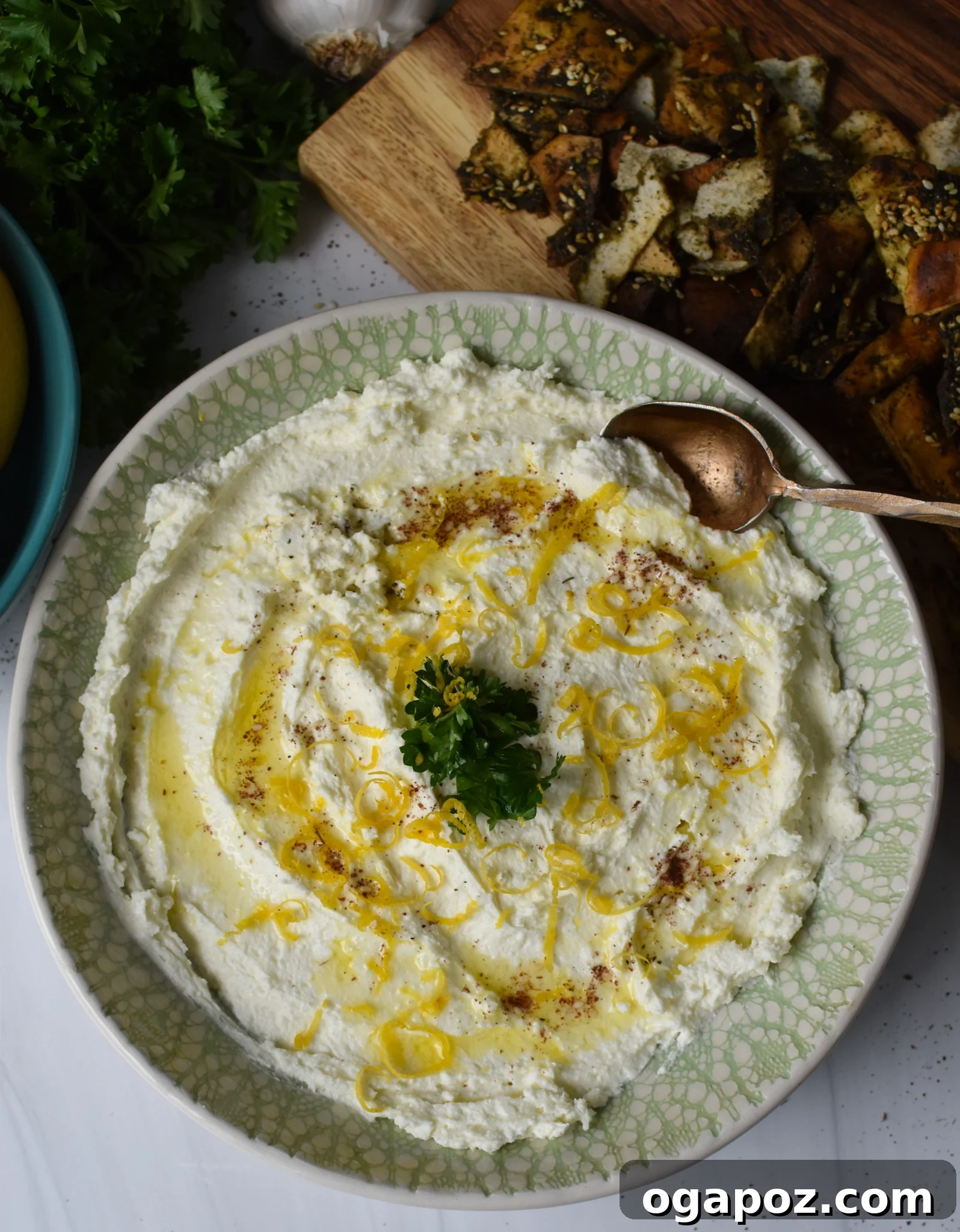 Tangy Lemon Feta Dip 7 Close-up of Lemon Whipped Feta Dip in a bowl with a spoon, highlighting its creamy texture.