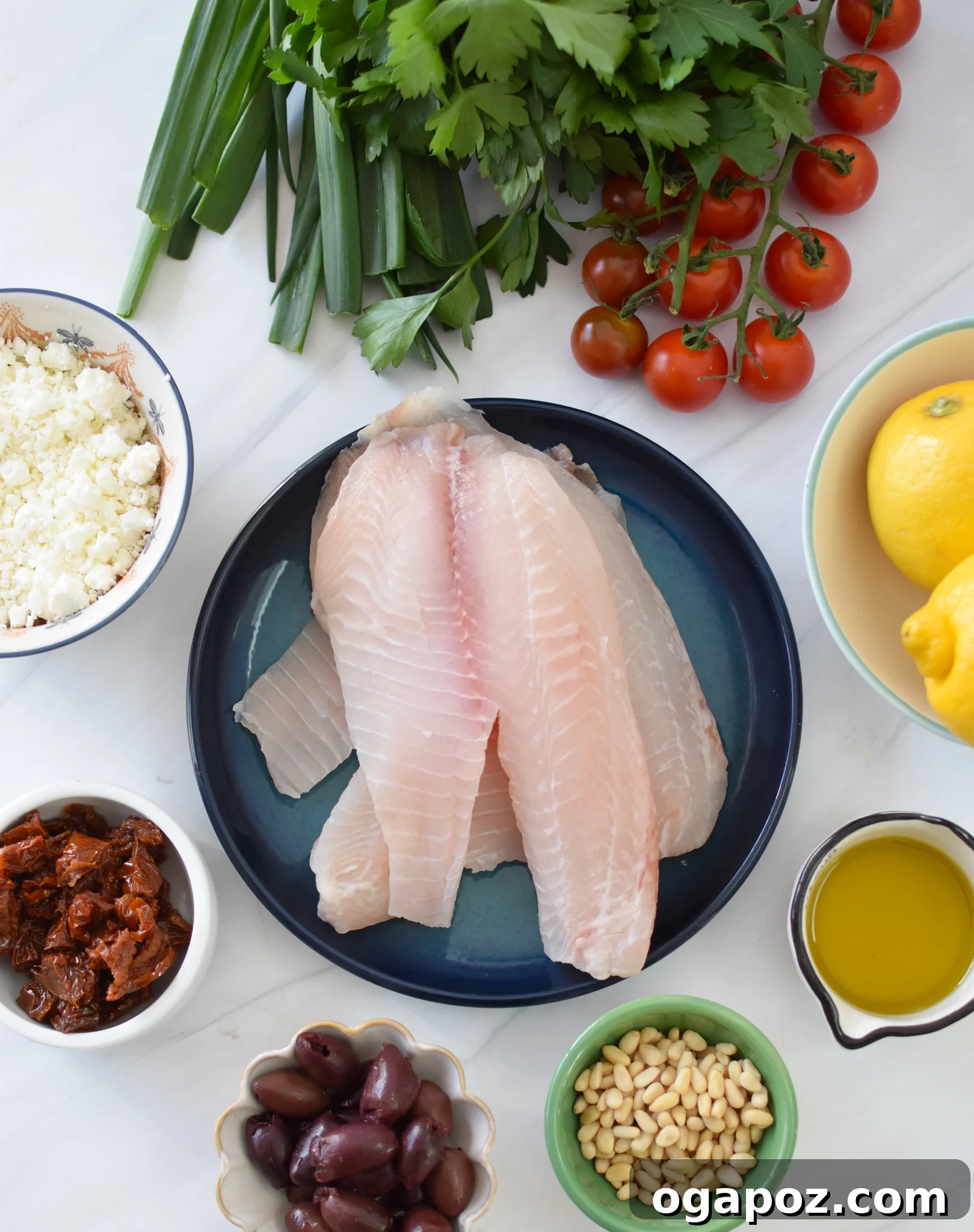 Lemon Herb Greek Tilapia Bake 3 Fresh ingredients for Greek Baked Tilapia including tilapia fillets, lemon, herbs, and olive oil.