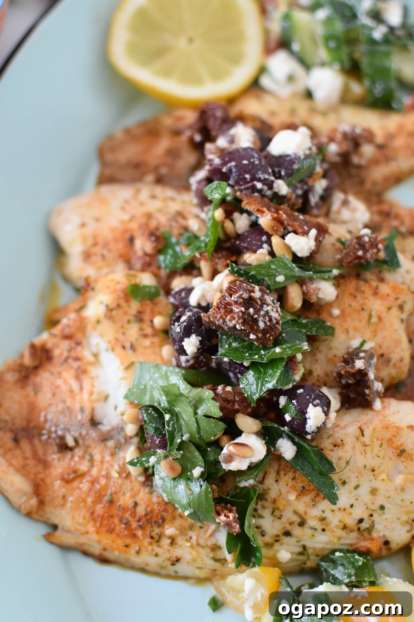 Lemon Herb Greek Tilapia Bake 4 Greek Baked Tilapia ready in a skillet with lemon slices.