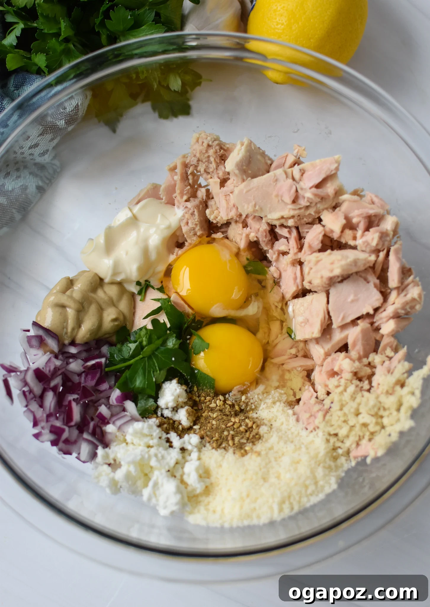 Zesty Mediterranean Tuna Fritters 5 All Mediterranean Tuna Patties Recipe ingredients in a mixing bowl before combining.