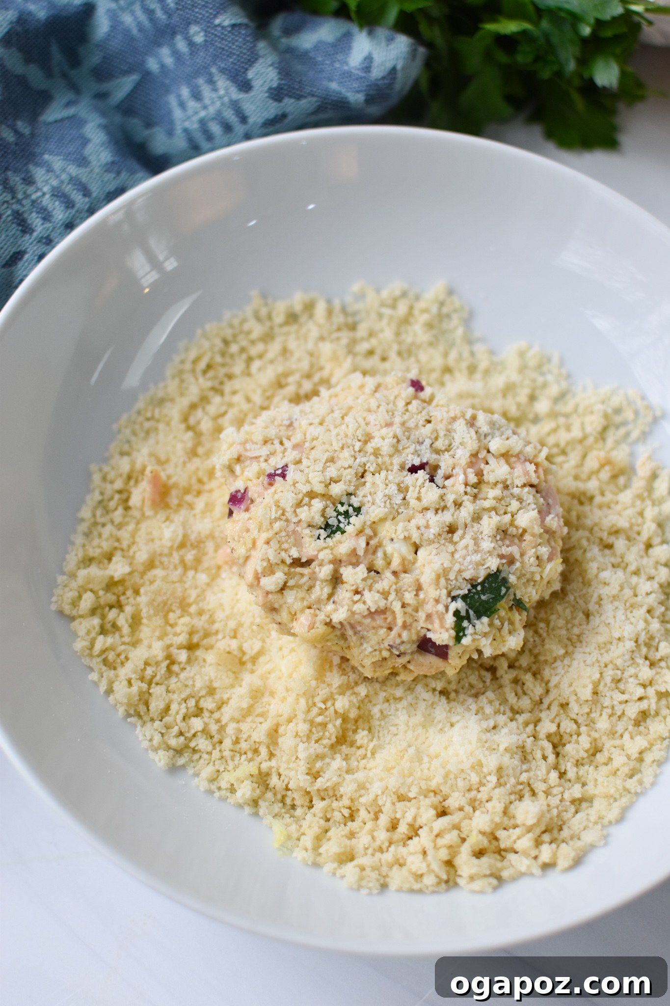 Zesty Mediterranean Tuna Fritters 8 Mediterranean Tuna Patties Recipe being coated with breadcrumbs.