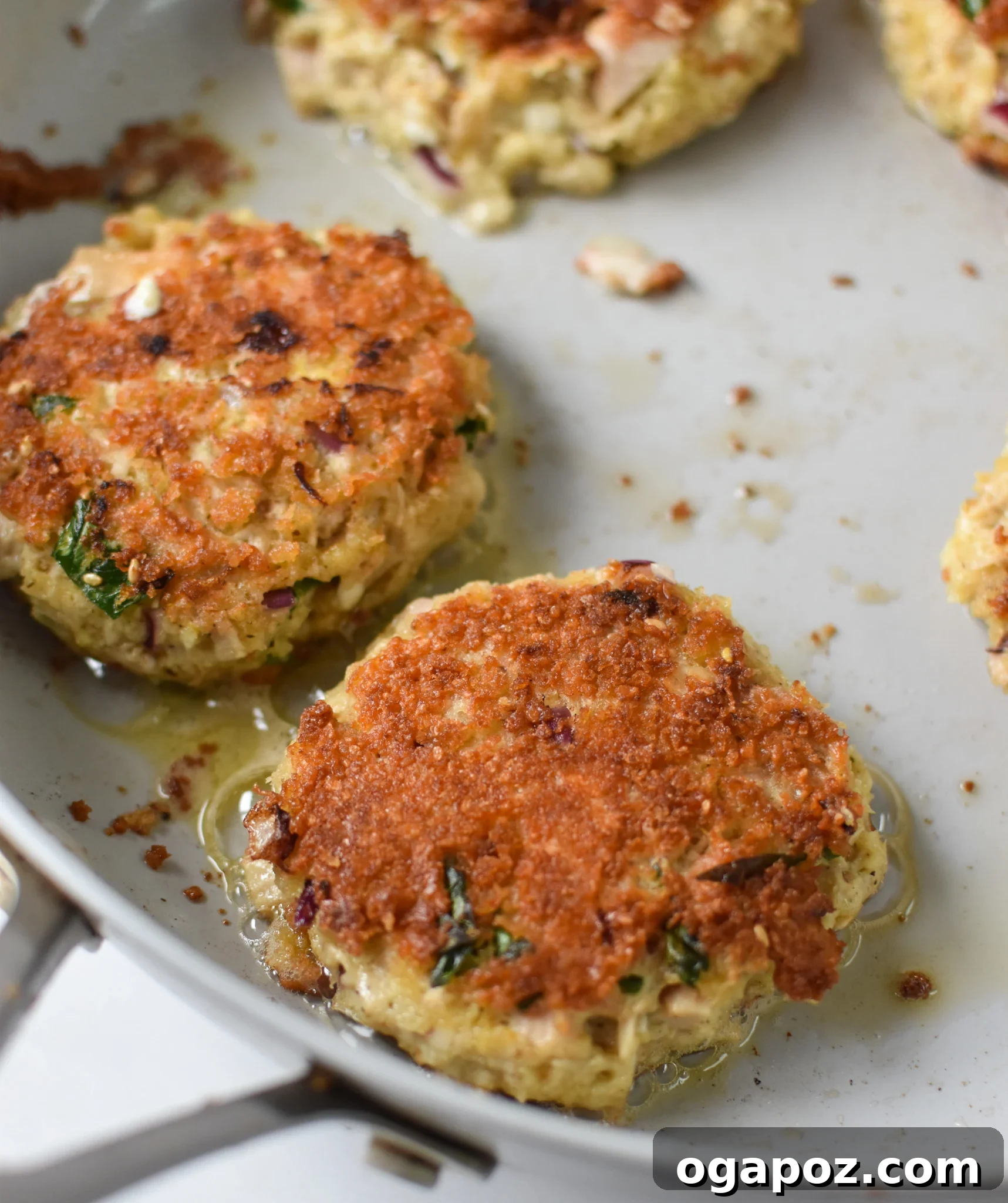 Zesty Mediterranean Tuna Fritters 9 Mediterranean Tuna Patties Recipe cooking in a skillet.