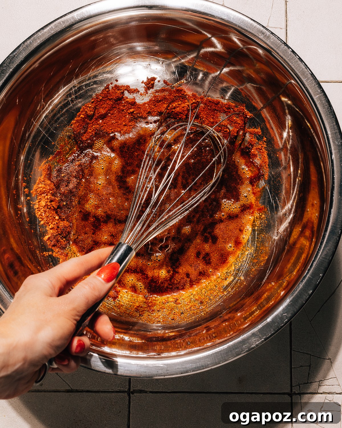 Step 2: Hot oil is being poured over the spices in a bowl, creating a sizzling effect.