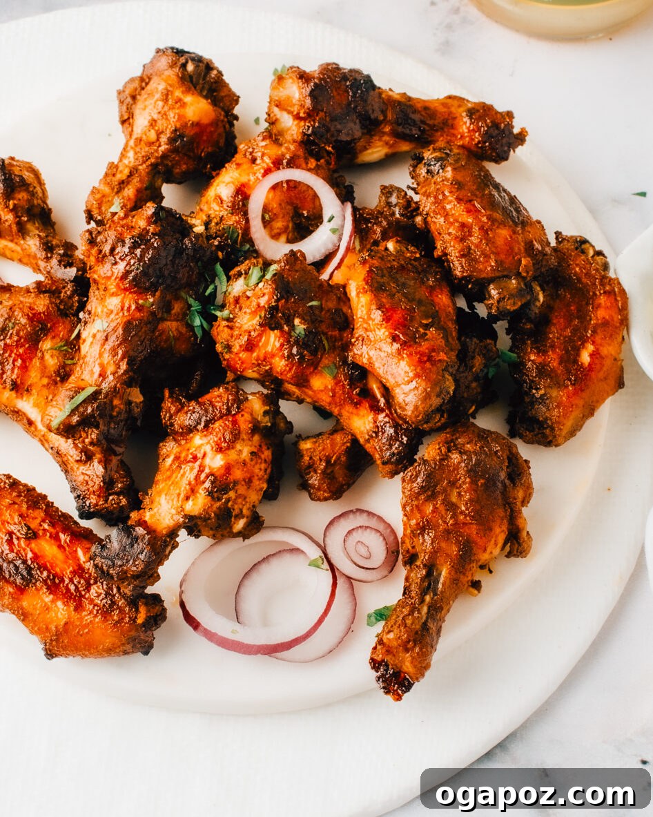 Crispy fried chicken pieces generously coated in Nashville hot sauce, served on a bed of white bread with pickles.