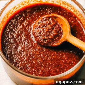 Nashville hot sauce with a spoon, ready to be served.