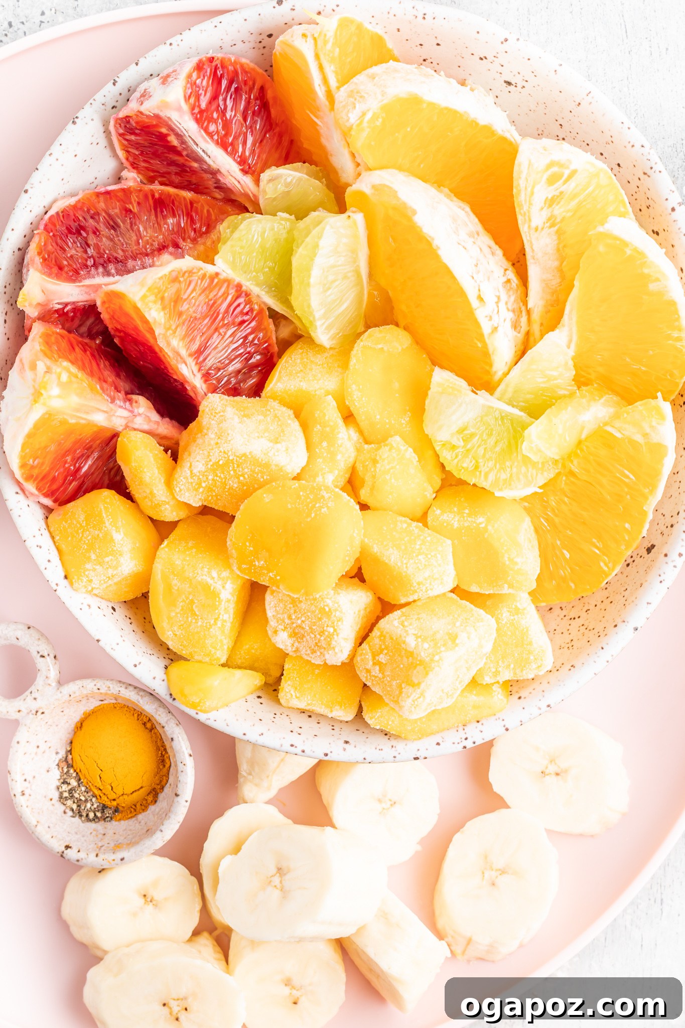Sunshine Orange Smoothie 3 A selection of fresh ingredients for the Orange Smoothie Recipe arranged in a bowl.
