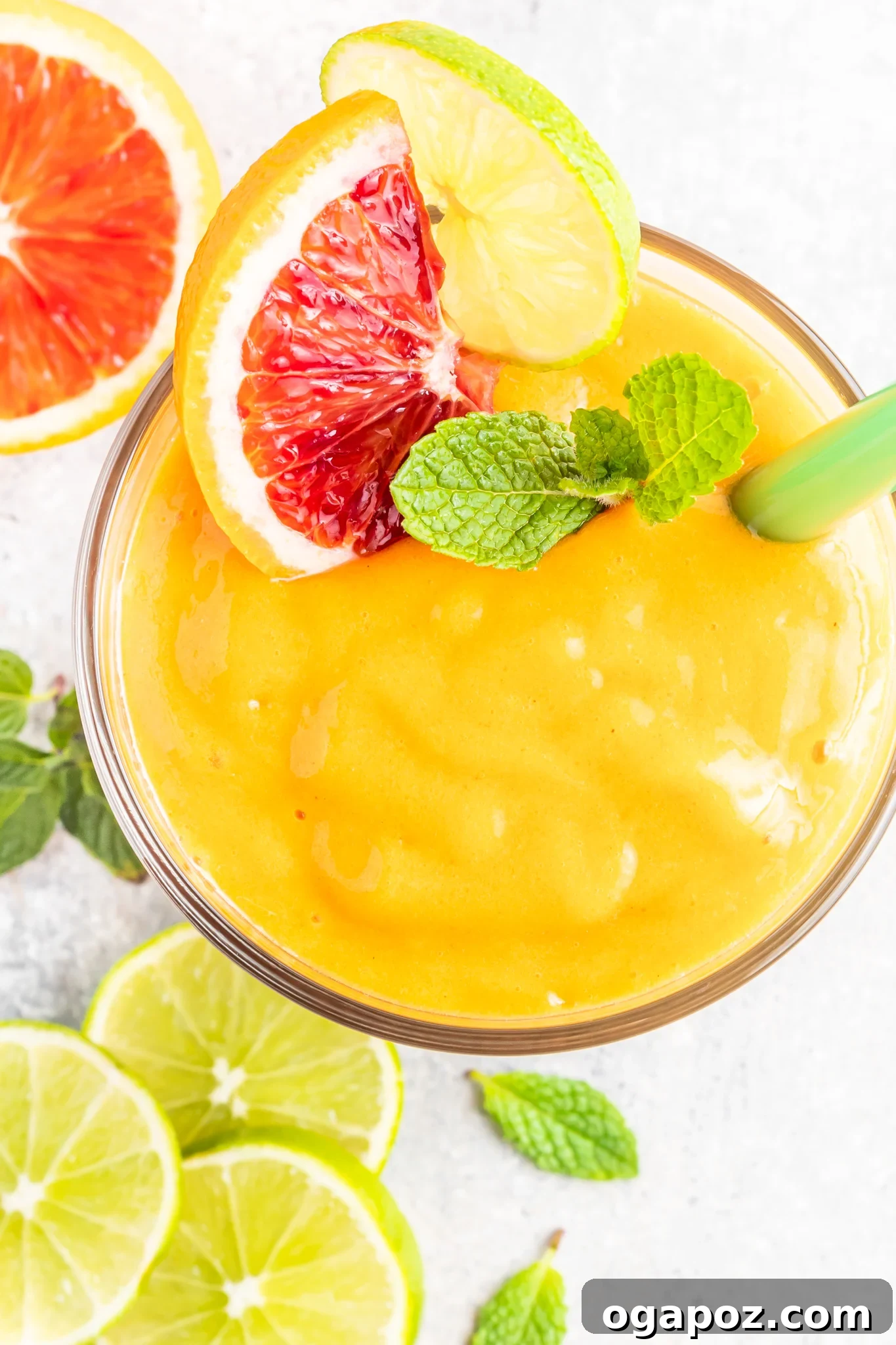Sunshine Orange Smoothie 4 Orange Smoothie garnished with fresh oranges and mint leaves, showcasing its vibrant freshness.