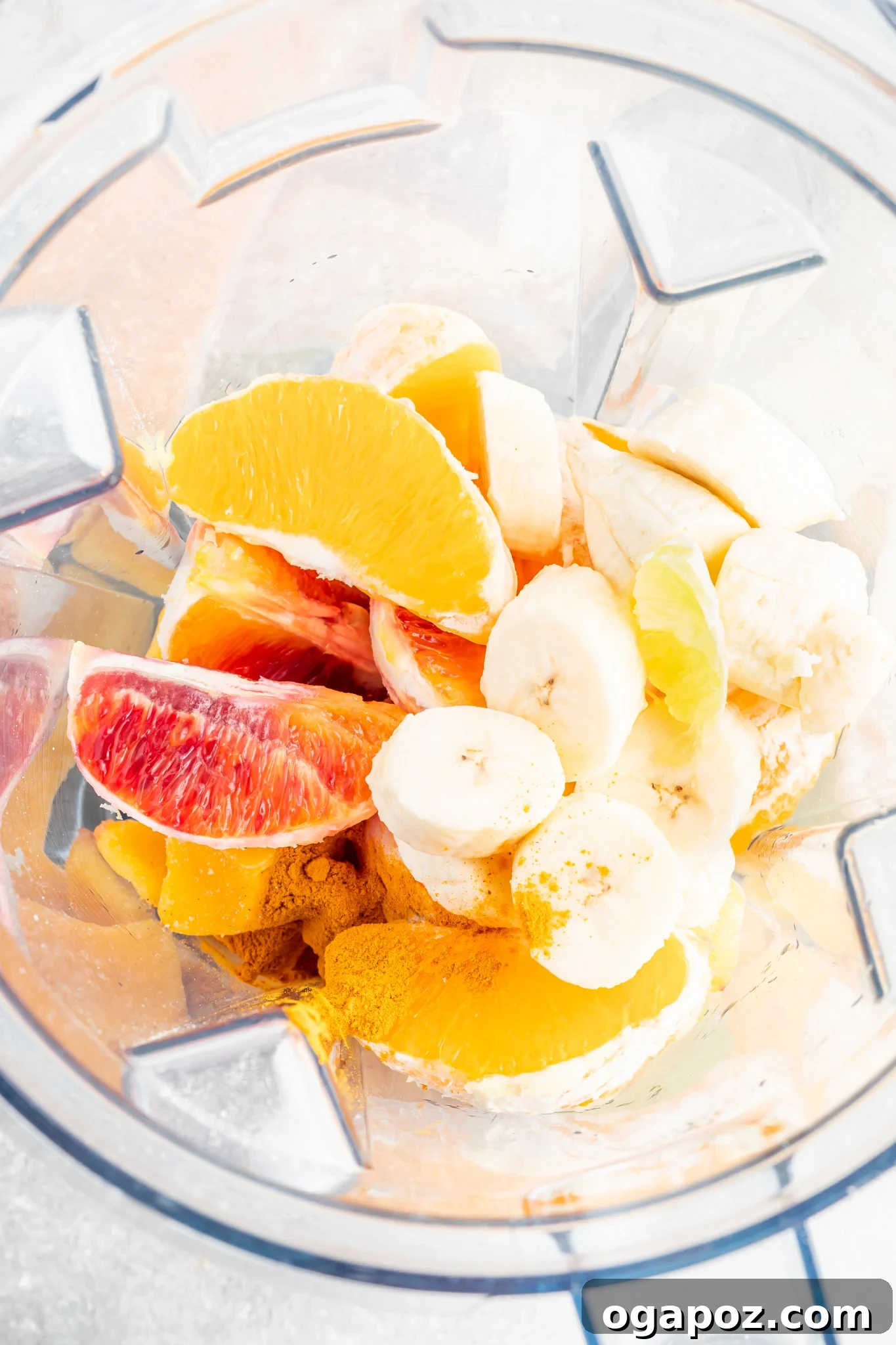 Sunshine Orange Smoothie 5 Ingredients for Orange Smoothie being blended in a high-speed blender for a smooth consistency.