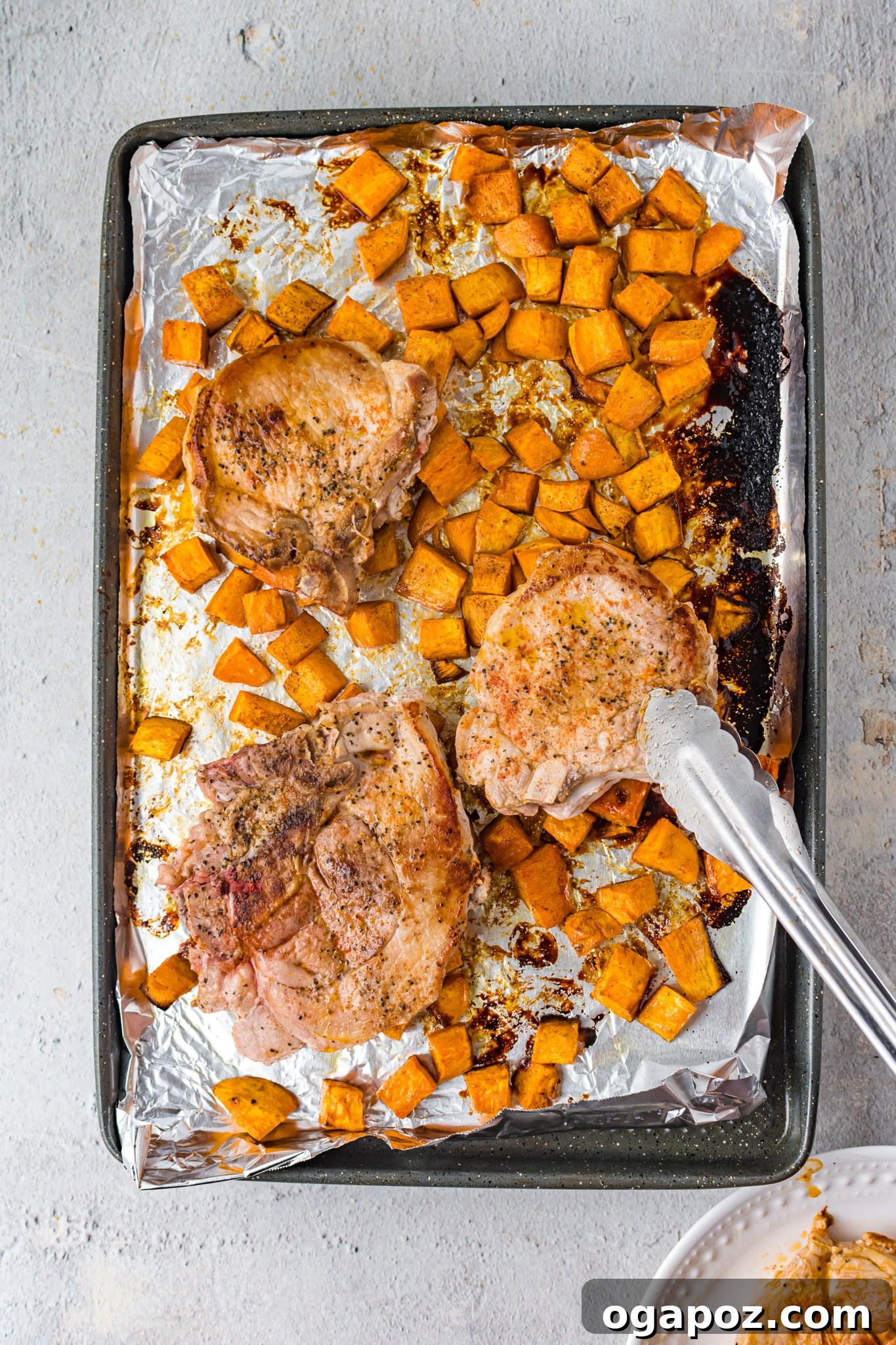 Maple Bourbon Pork Chops Recipe being moved with tongs.