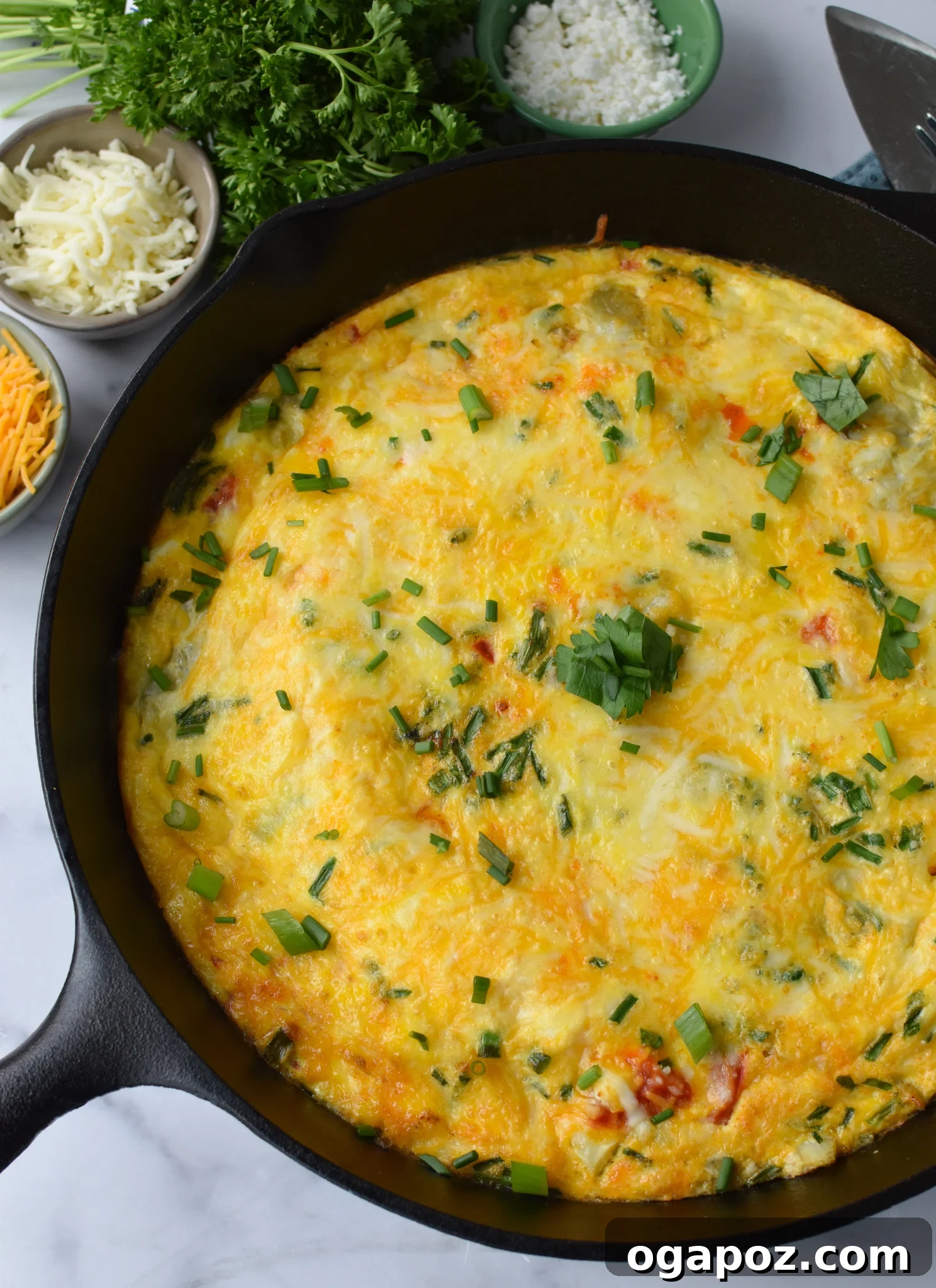 Mediterranean Vegetable Frittata Recipe with fresh chives, served on a rustic plate.