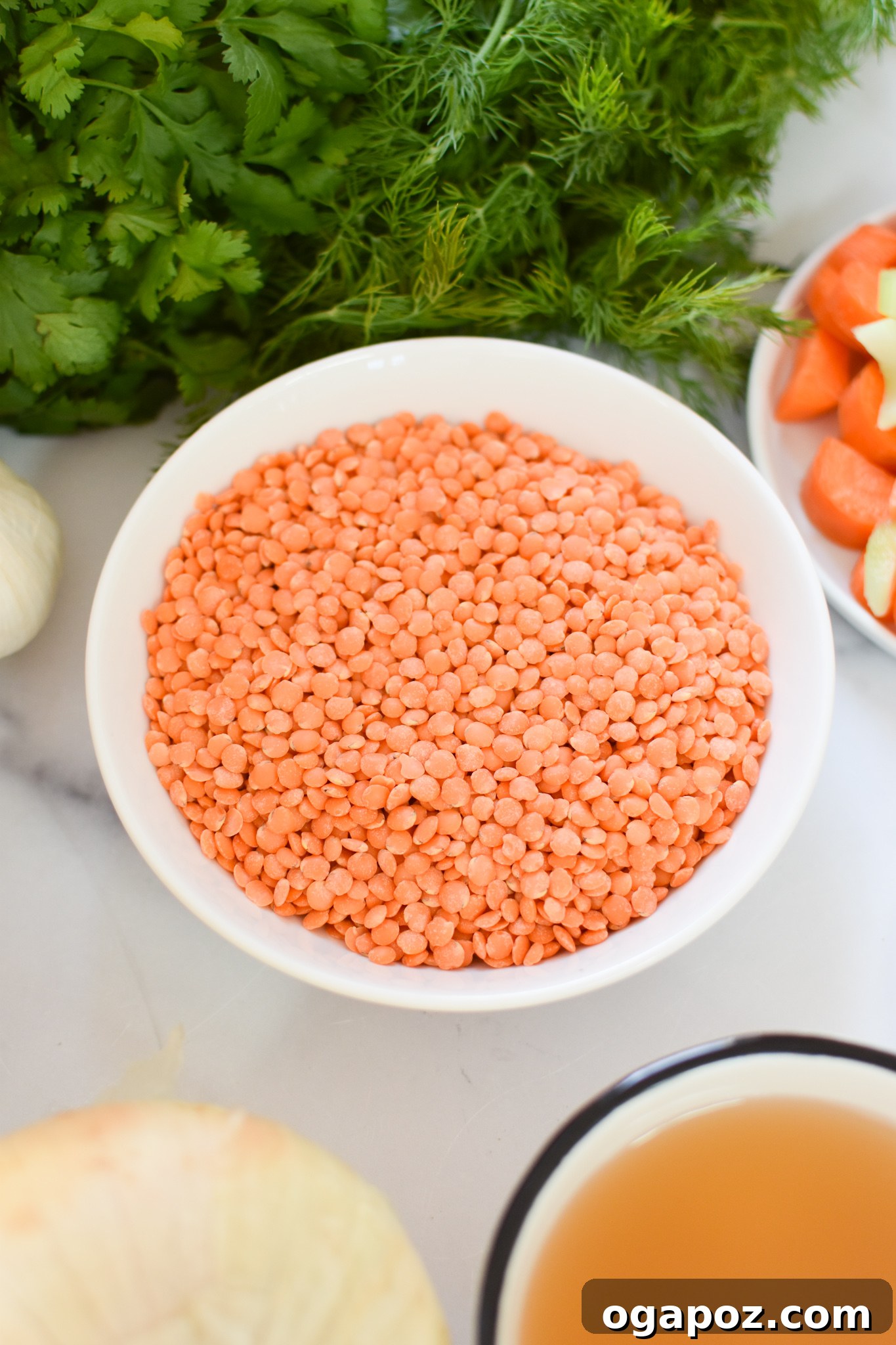 Bright and Zesty Lentil Soup 4 A close-up view of vibrant red lentils in a wooden bowl, ready to be prepared for the Lemon Lentil Soup recipe.