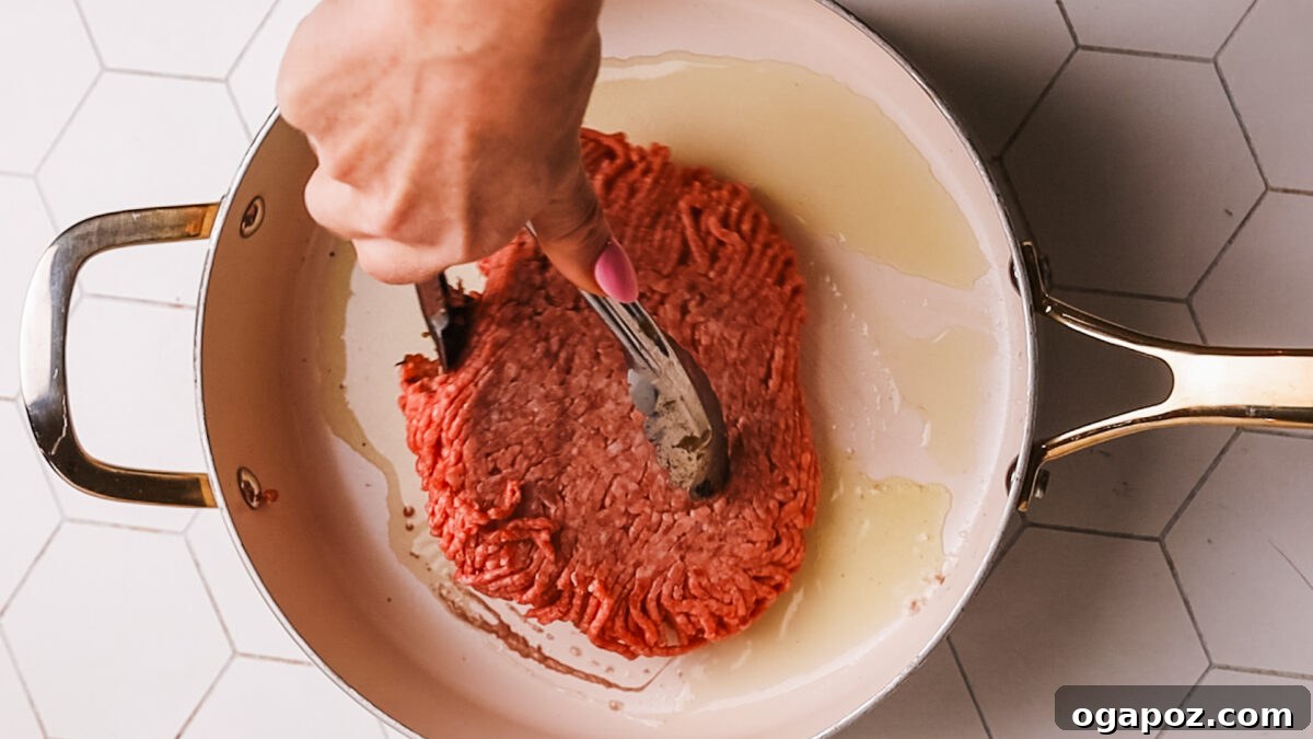 Sauce-Simmered Pasta Feast 4 Ground beef searing in a Dutch oven, developing a rich brown crust.