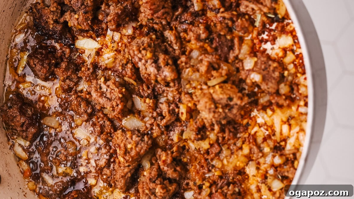 Sauce-Simmered Pasta Feast 7 Fully cooked ground beef and softened onions in the pot.