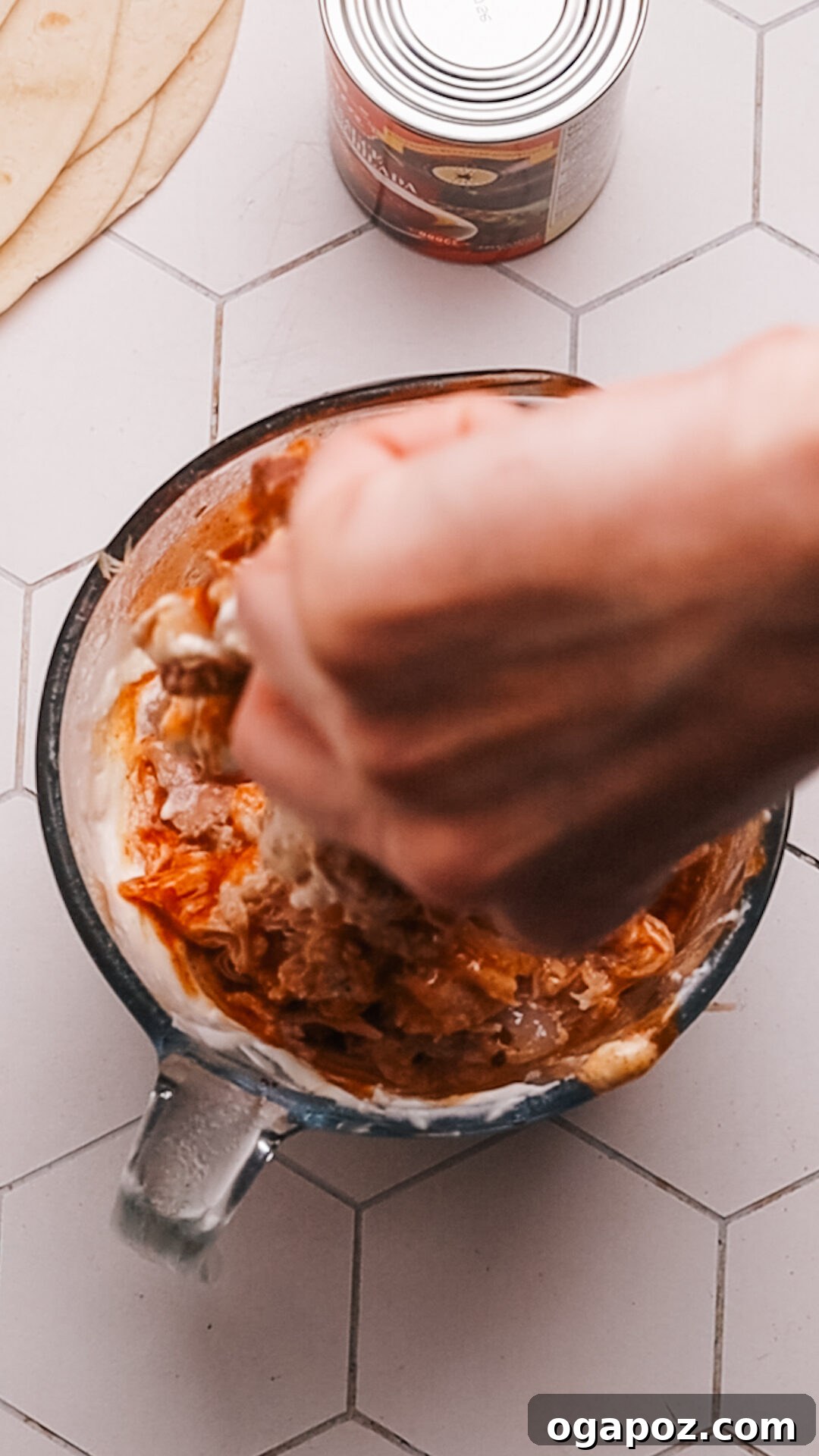 Creamy Chicken Enchilada Bake 5 Adding enchilada sauce to the chicken filling for Chicken Enchilada Casserole.