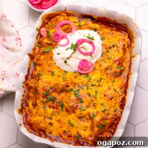 Chicken enchilada casserole or chicken tortilla casserole topped with sour cream and pickled onions.