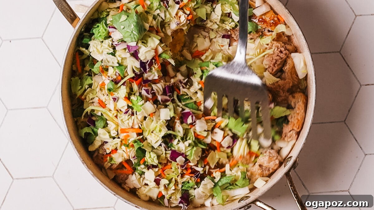 15 Minute Savory Egg Roll Bowl 8 adding cabbage to ground meat
