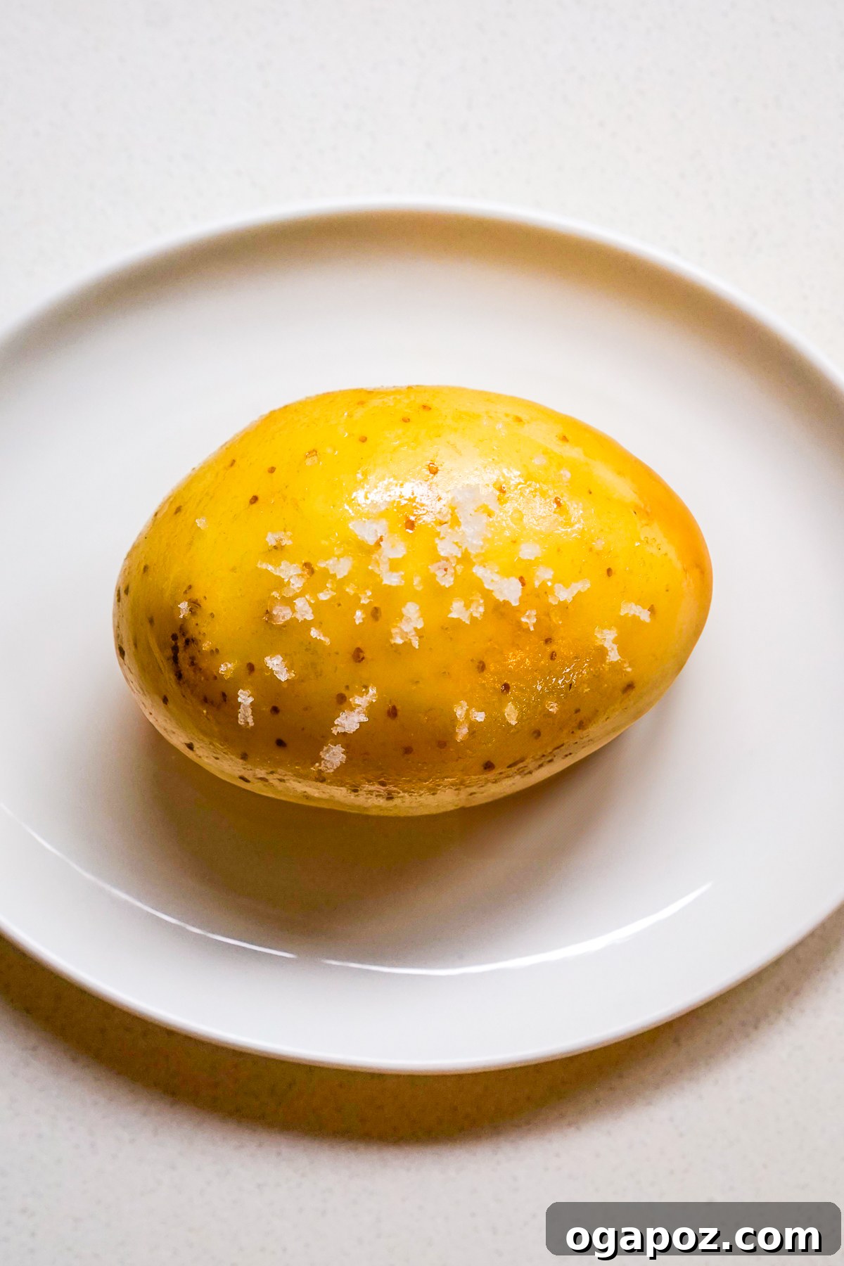 Potato being poked with a fork before microwaving
