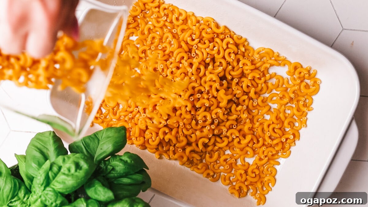 Cheeseburger Casserole 4 Adding uncooked pasta to the baking dish.