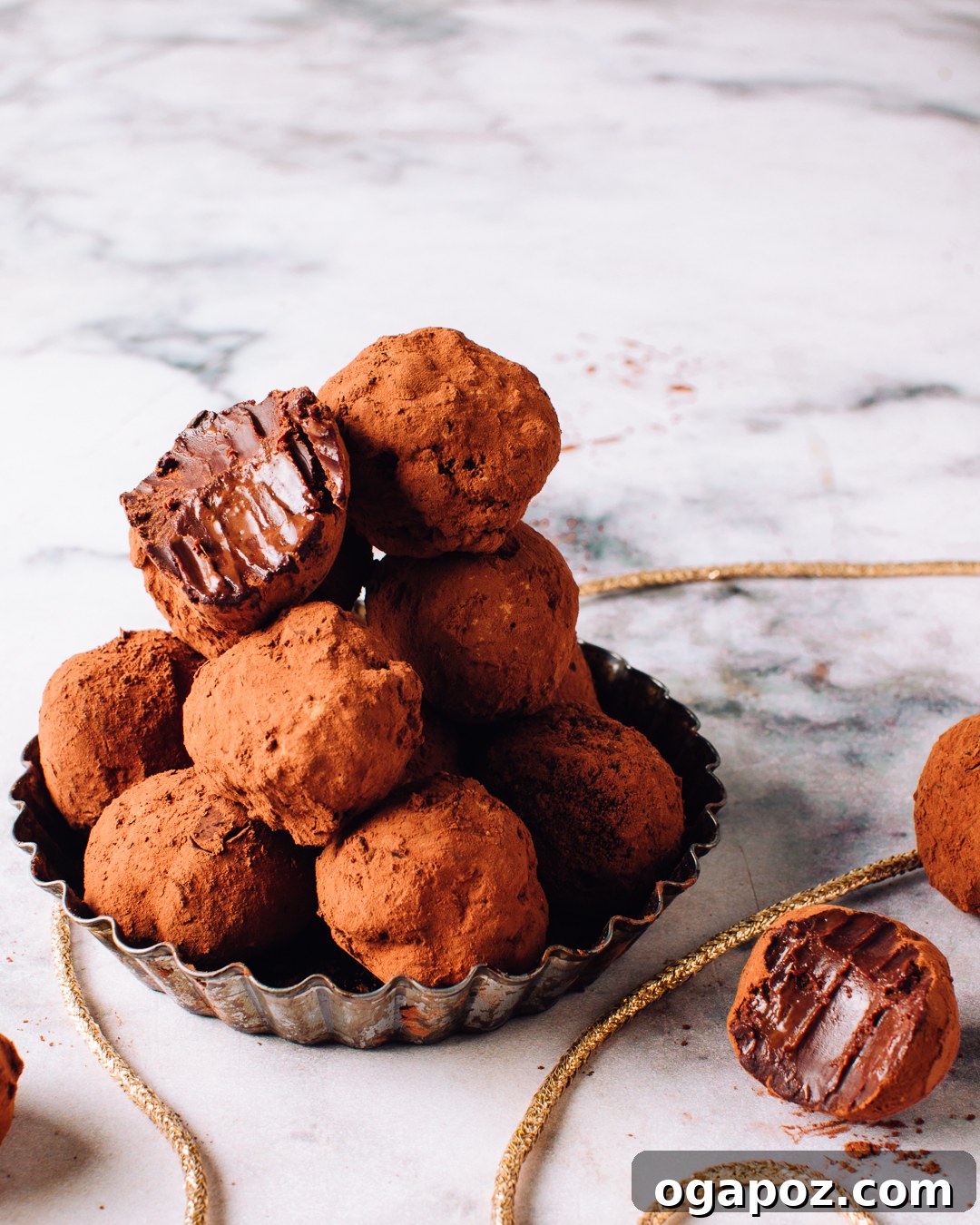 Effortless 3-Ingredient Chocolate Truffles 2 A pile of rich, homemade chocolate truffles, dusted with cocoa powder and ready to be enjoyed.