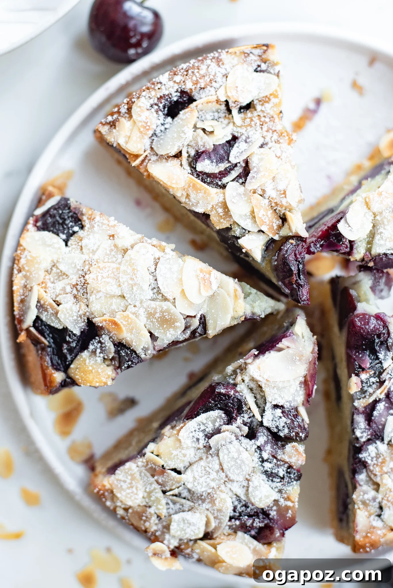 Decadent Cherry Almond Cake 4 A close-up of a Cherry Almond Cake slice, highlighting the tender crumb and the vibrant, baked cherries.