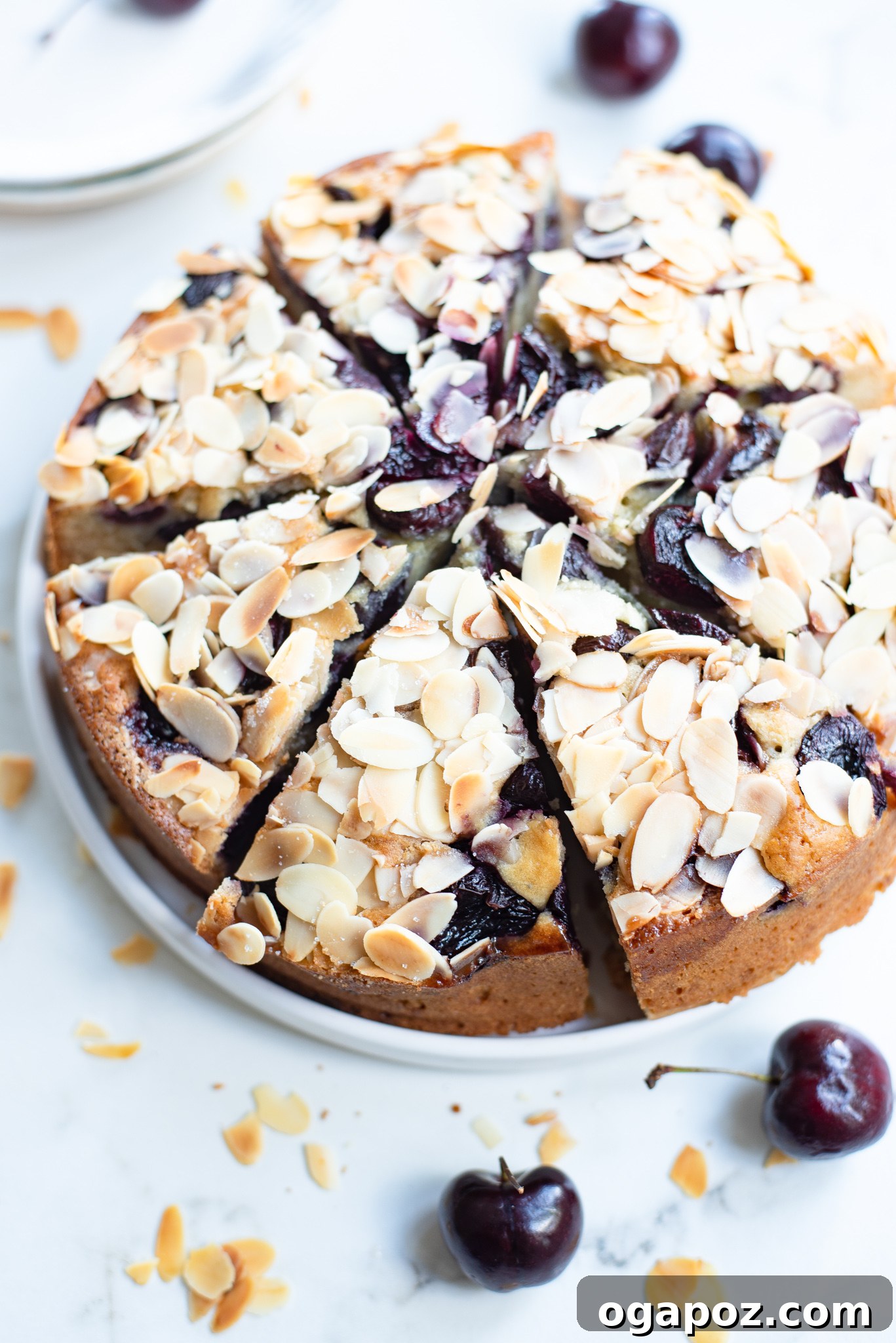 Decadent Cherry Almond Cake 5 Cherry Almond Cake with fresh cherries scattered over the top, ready for baking.
