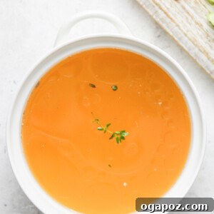 Homemade Chicken Broth in a white bowl.