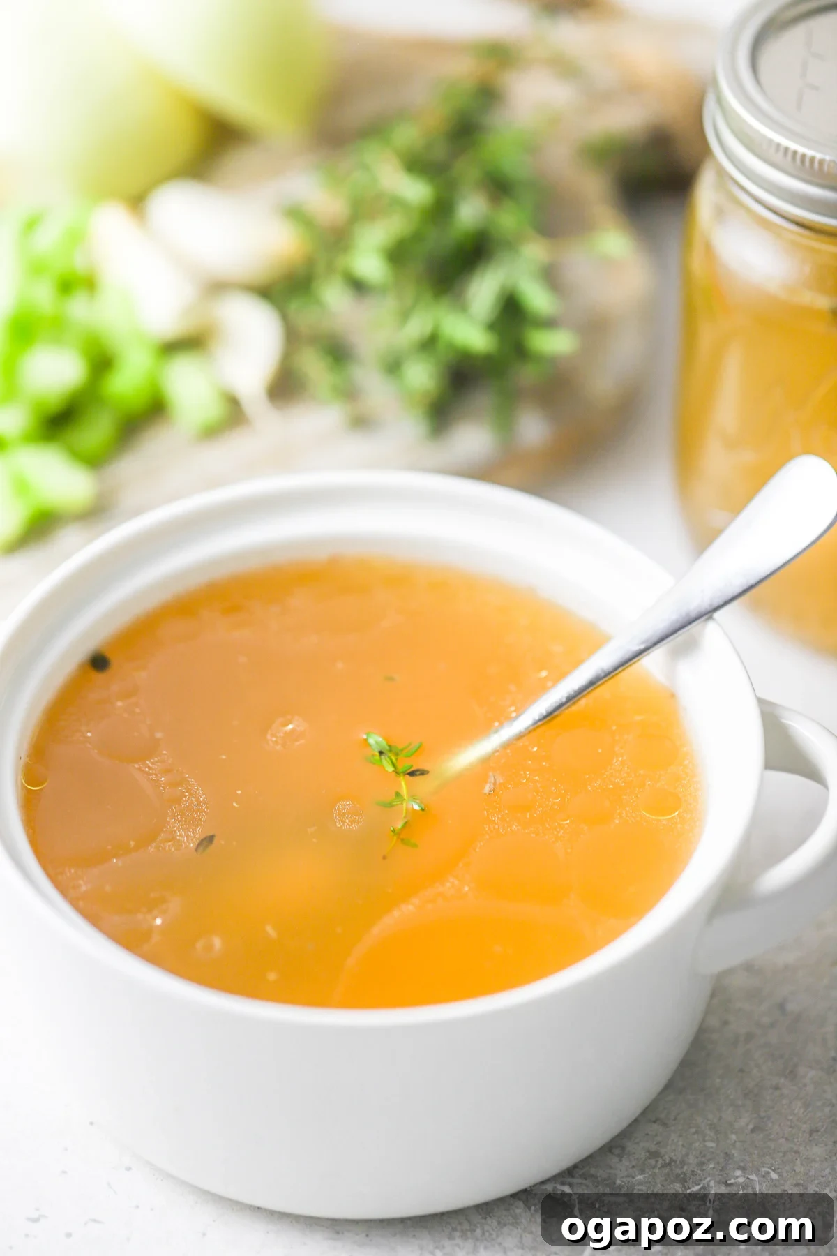 A beautifully clear, golden bowl of Homemade Chicken Broth, ready for enjoyment.