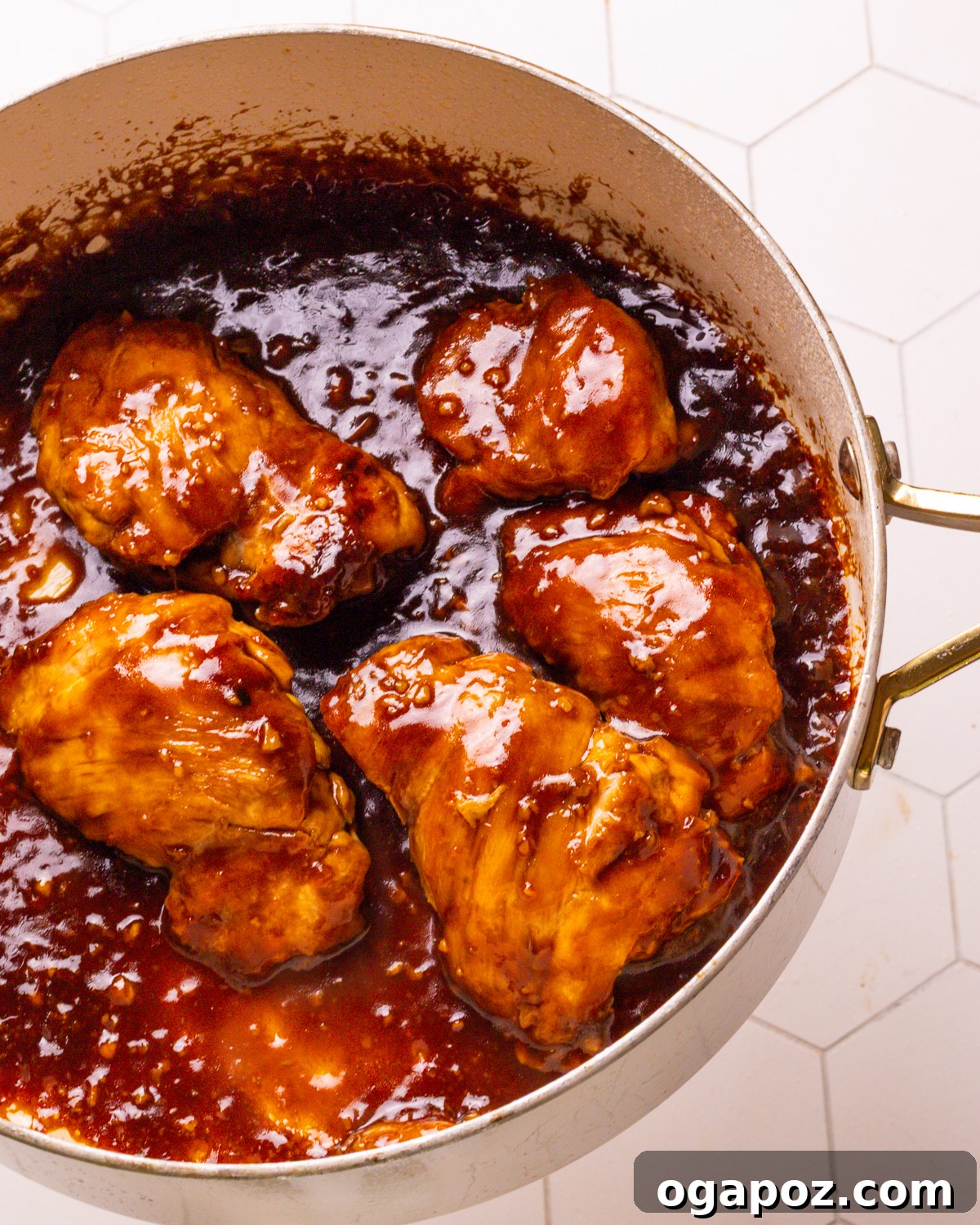 Delicious 30-Minute Teriyaki Bowl 5 Chicken pieces sizzling in a hot skillet, beginning to brown.