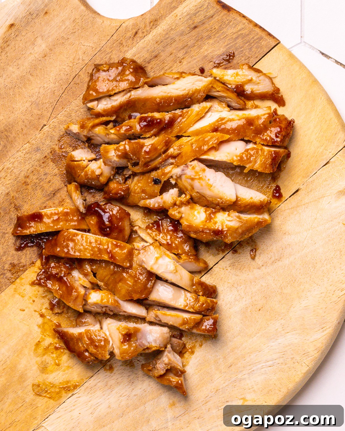 Delicious 30-Minute Teriyaki Bowl 6 Teriyaki sauce being poured over browned chicken in a skillet, coating each piece.
