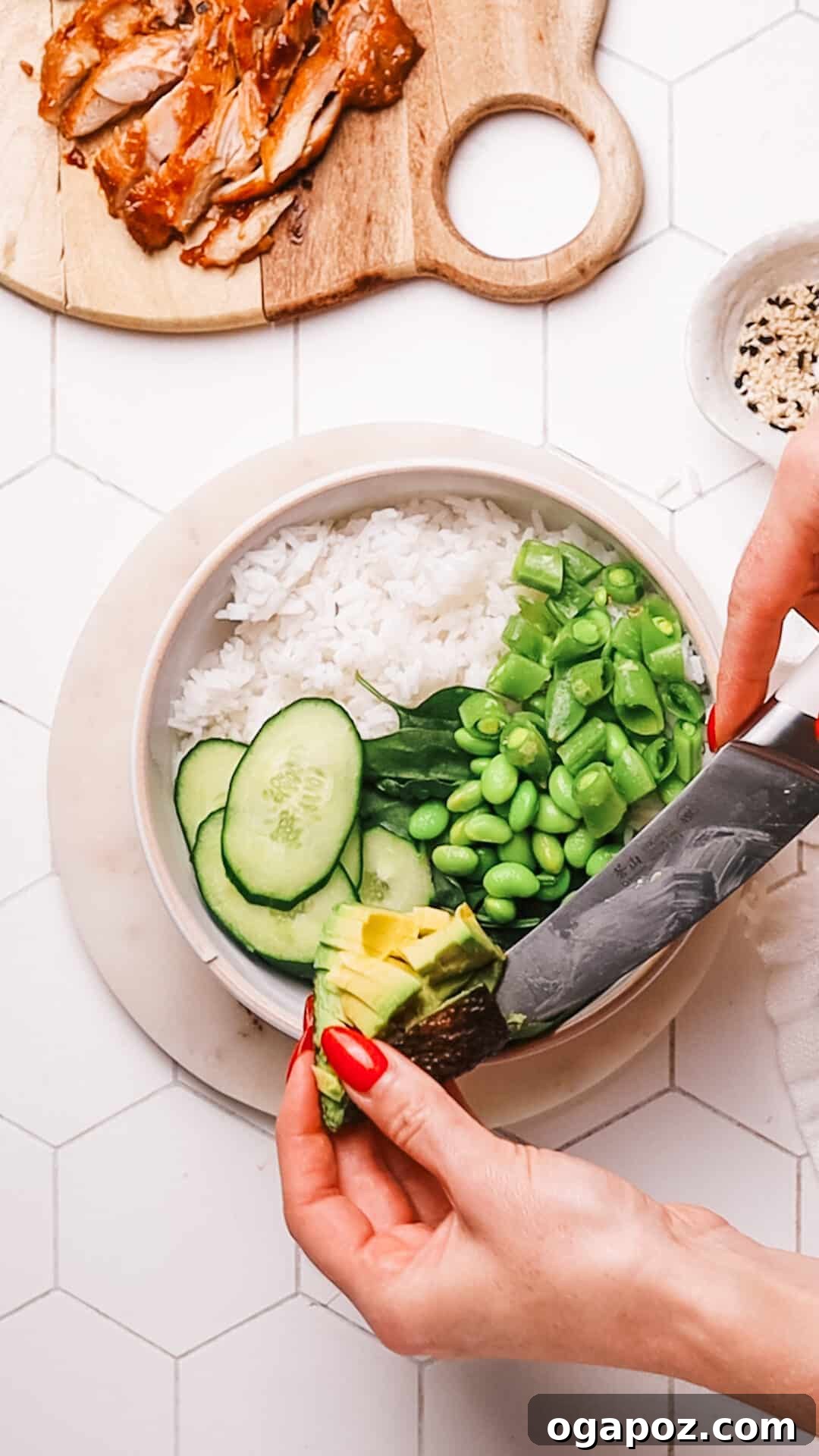 Delicious 30-Minute Teriyaki Bowl 7 A beautifully assembled teriyaki bowl with sauced chicken, rice, and fresh vegetables garnished with sesame seeds and green onions.