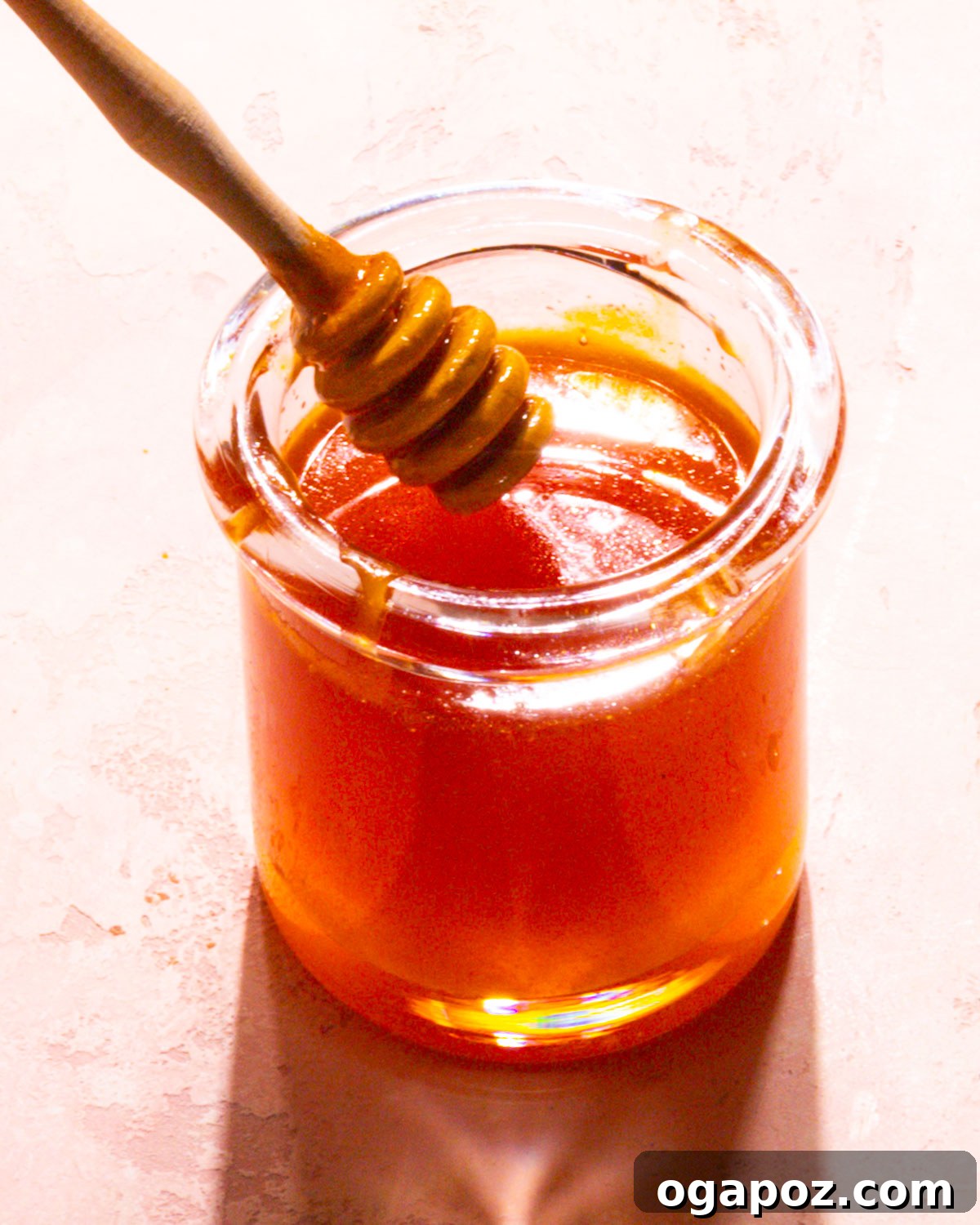 Fiery Honey Drizzle 6 Hot Honey Sauce in a serving dish with a spoon.